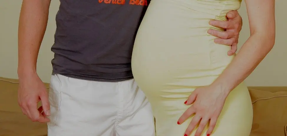 pregnant wife next to her husband