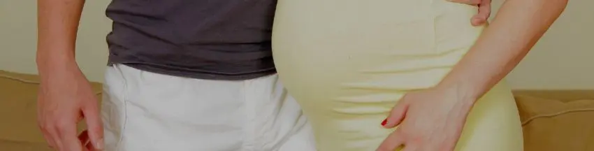pregnant woman standing next to her partner pregnant woman standing next to her partner