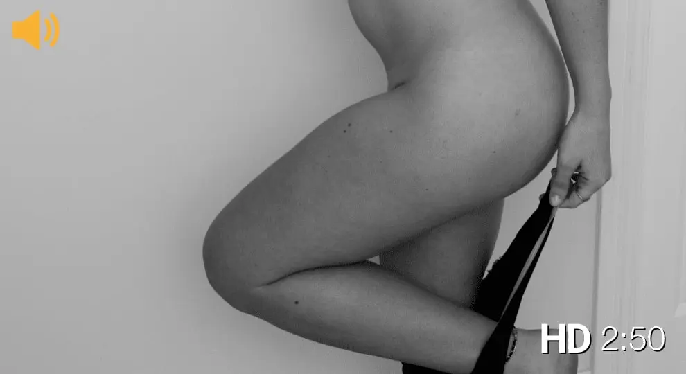 Black and white picture of a lady pulling off her black thong