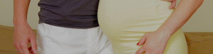pregnant woman standing next to her partner