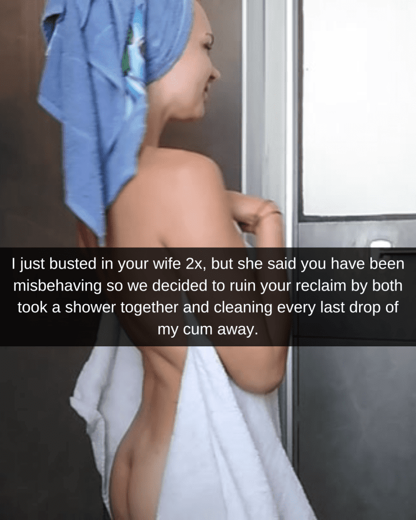 Woman standing in a white towel which has fell slightly, revealing her base ass and back. She wears a blue towel on her head and has just stepped out of the shower